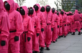 Fans gathered near Seoul's Gyeongbokgung Palace, led by marchers dressed in the bright pink uniforms worn by the show's mysterious masked agents