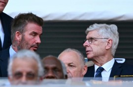 FIFA's Arsene Wenger talks with David Beckham during the Club World Cup's opening match between Egypt's Al Ahly and Inter Miami at the Hard Rock stadium