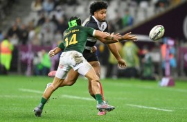 South Africa winger Cheslin Kolbe (L) tackles Barbarians centre Leicester Fainga'anuku at Cape Town Stadium