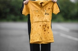 French cyclist Jacques Marinelli, who has died aged 99, holds the yellow jersey he wore for six days in the 1949 Tour de France in which he finished third