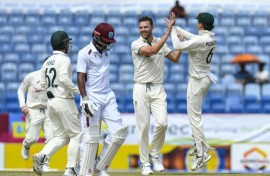 Josh Hazlewood (2R) celebrates removing West Indies opener Kraigg Brathwaite for a duck