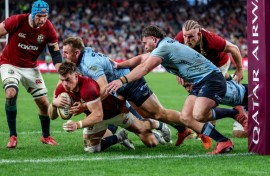 British and Irish Lions' Huw Jones (bottom) scores a try against the NSW Waratahs