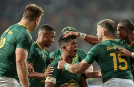 South Africa centre Canan Moodie (C) is congratulated after scoring a try against Italy.