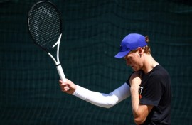 Italy's Jannik Sinner touches his shoulder during a training session at Wimbledon