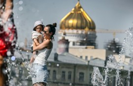 People cool off in front of Moscow's Christ the Saviour Cathedral, as the Russian capital sweltered under record heat