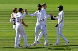 England's Shoaib Bashir (C) celebrates with team-mates Chris Woakes and Joe Root (L) after taking the clinching wicket in a 22-run win over India in the third Test at Lord's