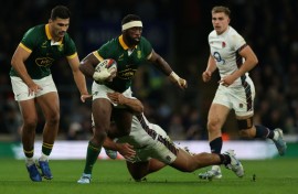South Africa captain Siya Kolisi (C) in action against England at Twickenham last season.