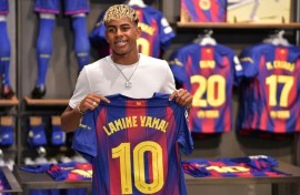 Lamine Yamal with the club's number 10 shirt previously worn by legend Lionel Messi