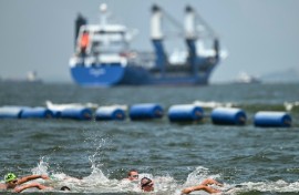 Swimmers compete in the men's 10km in the sea off Singapore