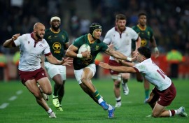 South Africa winger Edwill van der Merwe (C) bursts past Georgia defenders in Mbombela.