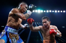 Manny Pacquiao (right) connects with Mario Barrios during their WBC welterweight title fight that ended in a majority draw