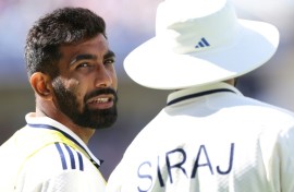 India's Jasprit Bumrah (L) speaks with Mohammed Siraj
