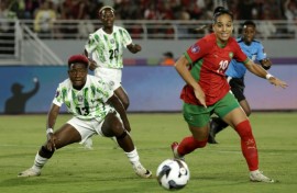 Nigeria midfielder Deborah Abiodun (L) watches as Morocco forward Sanaa Mssoudy chases the ball in Rabat