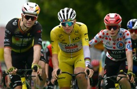 Team Visma riders Wout van Aert (L) and Jonas Vingegaard congratulate Tadej Pogacar at the end of stage 20