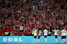 Tottenham Hotspur's players celebrate a goal in front of Arsenal fans during their friendly exhibition football match at the Kai Tak Stadium in Hong Kong on July 31, 2025.