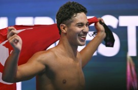 Tunisia's Ahmed Jaouadi grabbed gold in the 1,500m freestyle ahead of Germany's Sven Schwarz and Olympic champion Bobby Finke