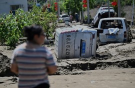 Damaged cars seen at the end of July in Huairou district, on the outskirts of Beijing after heavy rains caused widespread flooding