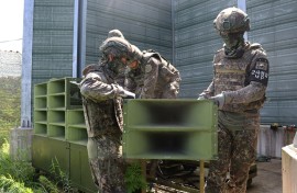 A handout photo taken on August 4 provided by the South Korean Defence Ministry shows soldiers removing loudspeakers at an undisclosed location in the DMZ