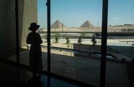 A visitor looks out towards the Giza pyramid complex as she tours the Grand Egyptian Museum in Giza on the southwestern outskirts of the capital Cairo on May 5, 2025