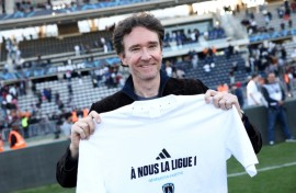 Antoine Arnault, whose family owns Paris FC, holds a t-shirt marking the club's promotion to Ligue 1