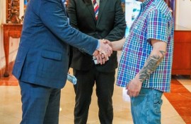 US Senator Chris Van Hollen (L) shakes hands with Salvadoran migrant Kilmar Abrego Garcia (R), a US resident wrongfully deported to his home country, at a hotel in San Salvador