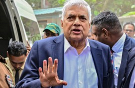 Sri Lanka's former president Ranil Wickremesinghe gestures as he arrives to appear before a court after his arrest