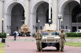 Members of the National Guard stand watch outside of Union Station in the US capital Washington, while President Donald Trump has threatened to deploy more troops to other Democratic-led cities like Baltimore and Chicago