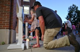 A vigil was held in Minneapolis for a church shooting in which two children were killed and 18 other people were injured