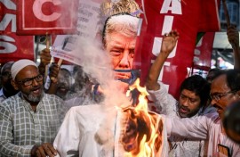 Activists burn an effigy of Trump to protest against tariff hikes during a demonstration in Kolkata