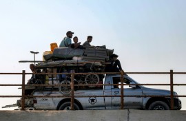 Displaced Gazans head south along a coastal road as the Israeli military gears up for a major new operation in the territory's north