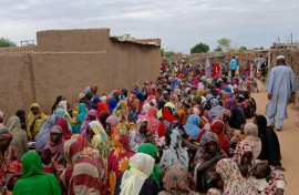 Sudanese residents gather to receive free meals in El-Fasher, a city besieged by Sudan's paramilitary Rapid Support Forces (RSF) for more than a year, in thr Darfur region
