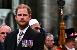 Britain's Prince Harry, the Duke of Sussex, looks on as his father leaves Westminster Abbey after being crowned King Charles III in 2023