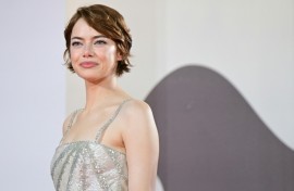 Emma Stone poses on the red carpet before the premiere of 'Bugonia'