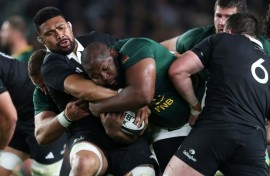 Ox Nche of South Africa is tackled by Ardie Savea