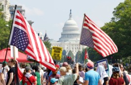 Demonstrators hold inverted US flags near the US Capitol during the "We Are All DC" national march calling for an end to the deployment of National Guard troops in Washington, DC
