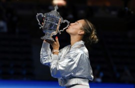 Aryna Sabalenka kisses the US Open trophy after retaining her title with a straight sets defeat of Amanda Anisimova