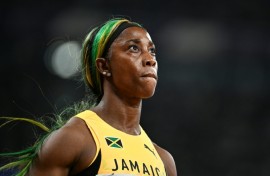 Shelly-Ann Fraser-Pryce glances at the giant screen in Tokyo after bringing down the curtain on her individual sprint career