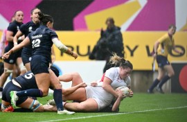 England prop Kelsey Clifford tumbles over the line to score a try during a 40-18 Women's Rugby World Cup quarter-final win over Scotland in Bristol