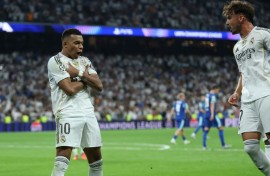 Kylian Mbappe celebrates his second penalty as Real Madrid came from behind to beat Marseille 2-1