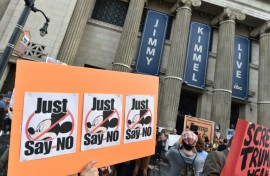 Demonstrators hold signs as they rally to protest the cancelation of the "Jimmy Kimmel Live!" show outside the El Capitan Entertainment Centre on Hollywood Boulevard, from where the show is broadcast in Hollywood, California