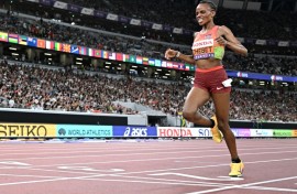 Kenya's Beatrice Chebet crosses the finish line to win the women's 5,000m