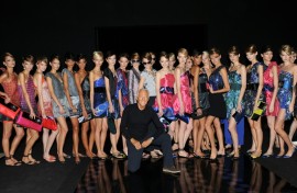 The death of legendary Italian designer Giorgio Armani (C), seen here at 2009's Milan Fashion Week, will overshadow this year's event