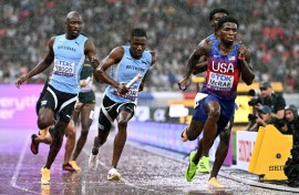 (From L) Botswana's Letsile Tebogo, Botswana's Bayapo Ndori, US' Jacory Patterson and US' Khaleb McRae compete in the men's 4x400m relay final