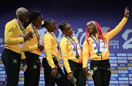 Leader of the pack: Shelly-Ann Fraser-Pryce takes one last picture with her sprint relay teammates