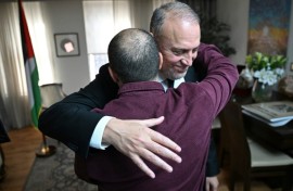 Husam Zomlot embraces a member of staff after Britain's Prime Minister Keir Starmer formally recognised a Palestinian state