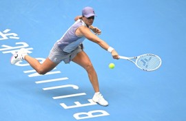 Poland’s Iga Swiatek hits a return to China’s Yuan Yue