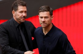 Real Madrid's Spanish coach Xabi Alonso (R) admitted his team deserved to lose the derby clash against Atletico Madrid led by Diego Simeone (L)