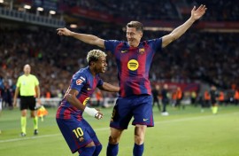 Barcelona's Polish forward Robert Lewandowski celebrates with Lamine Yamal after the winger set him up to score against Real Sociedad