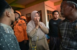 Relatives of missing students gather as search and rescue operations continue at a boarding school in East Java