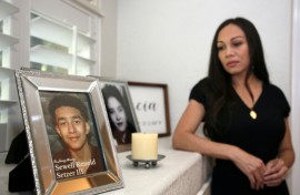 Megan Garcia looks at a picture of her son Sewell Setzer III, who she says fell in love with an AI chatbot that encouraged him to take his own life
